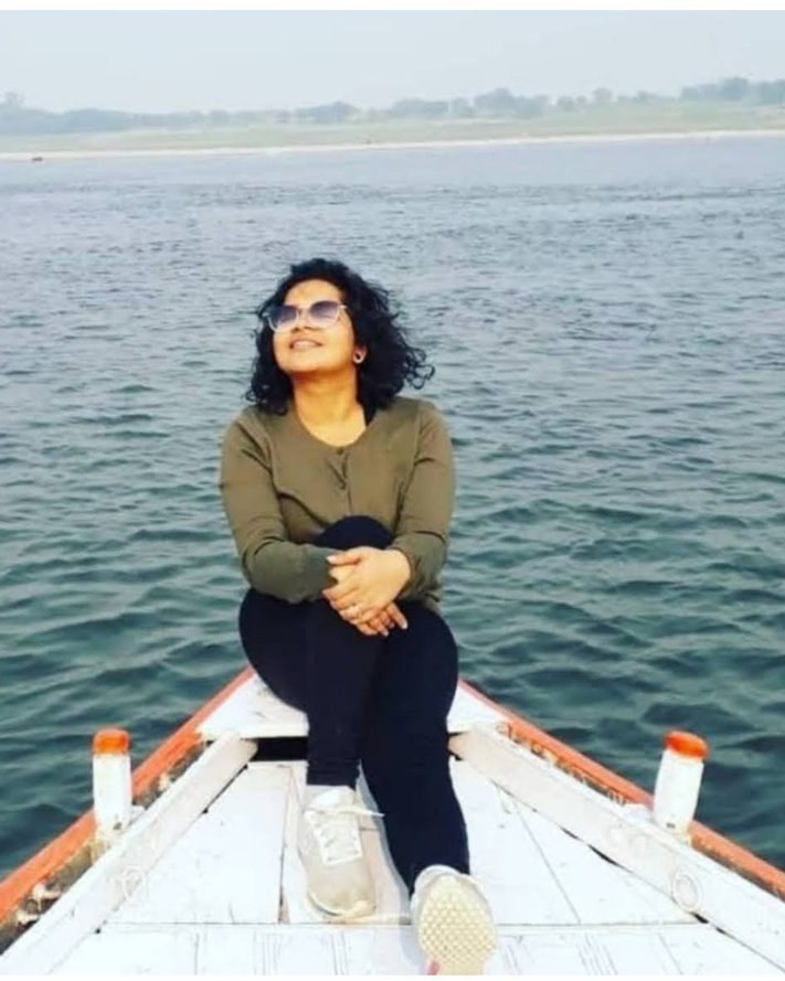Vanshali Sanwalka sitting at the bow of a boat on the Ganga